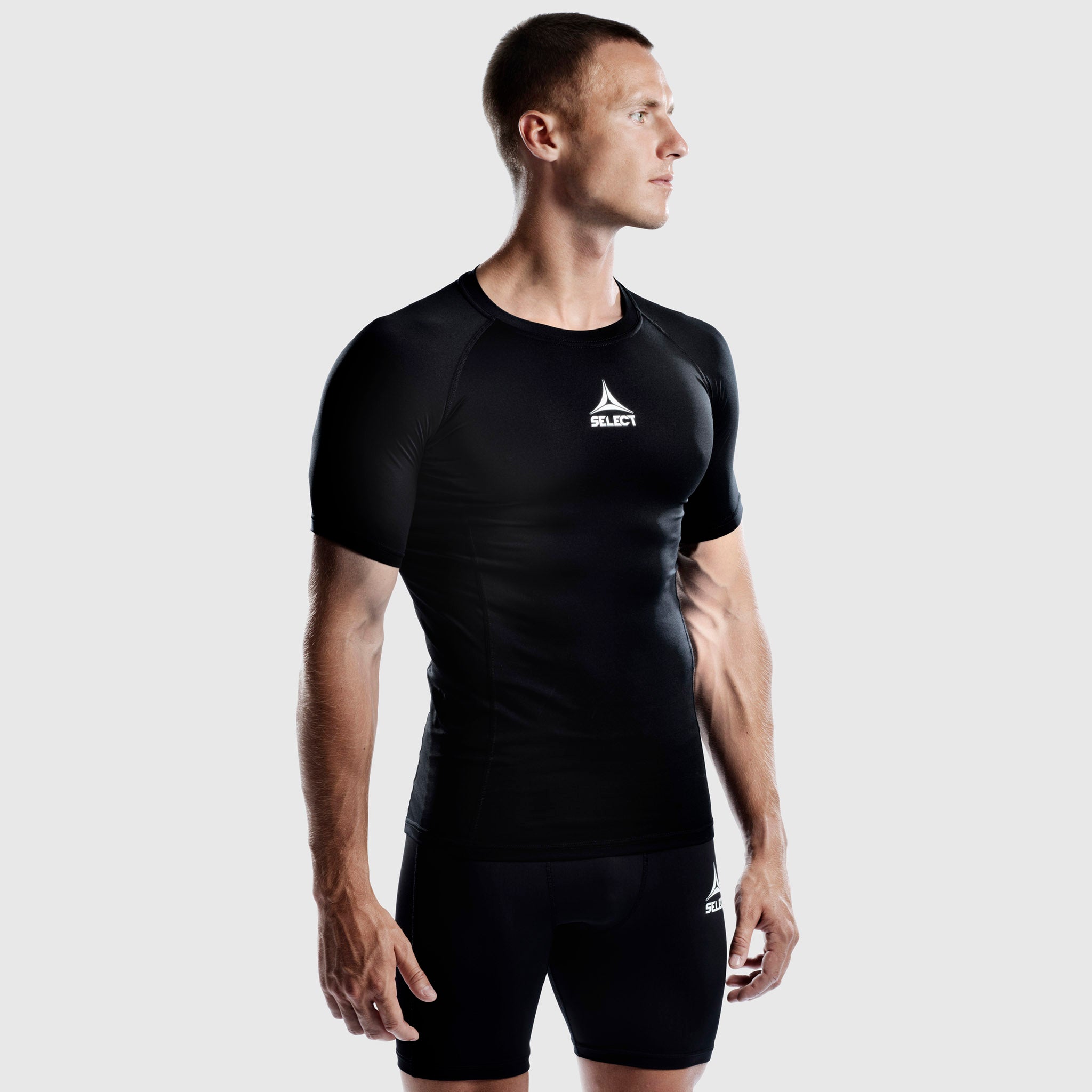 Man football player wearing black Shirt S/S Baselayer, front view